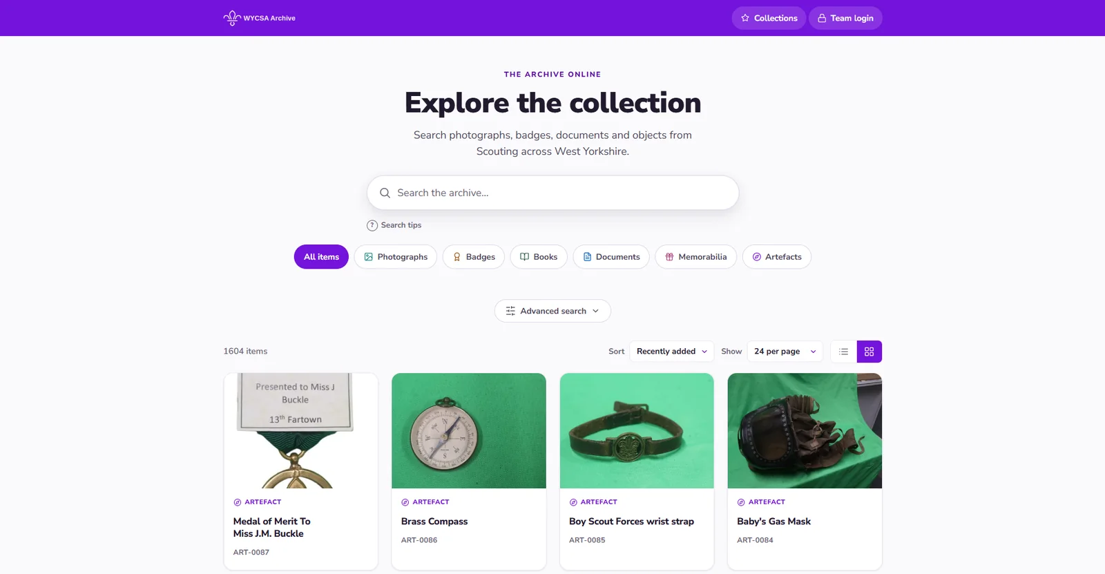 The archive front page: a search box, buttons for photographs, badges, books, documents, memorabilia and artefacts, and a grid of catalogued objects including a medal, a brass compass, a wrist strap and a gas mask.